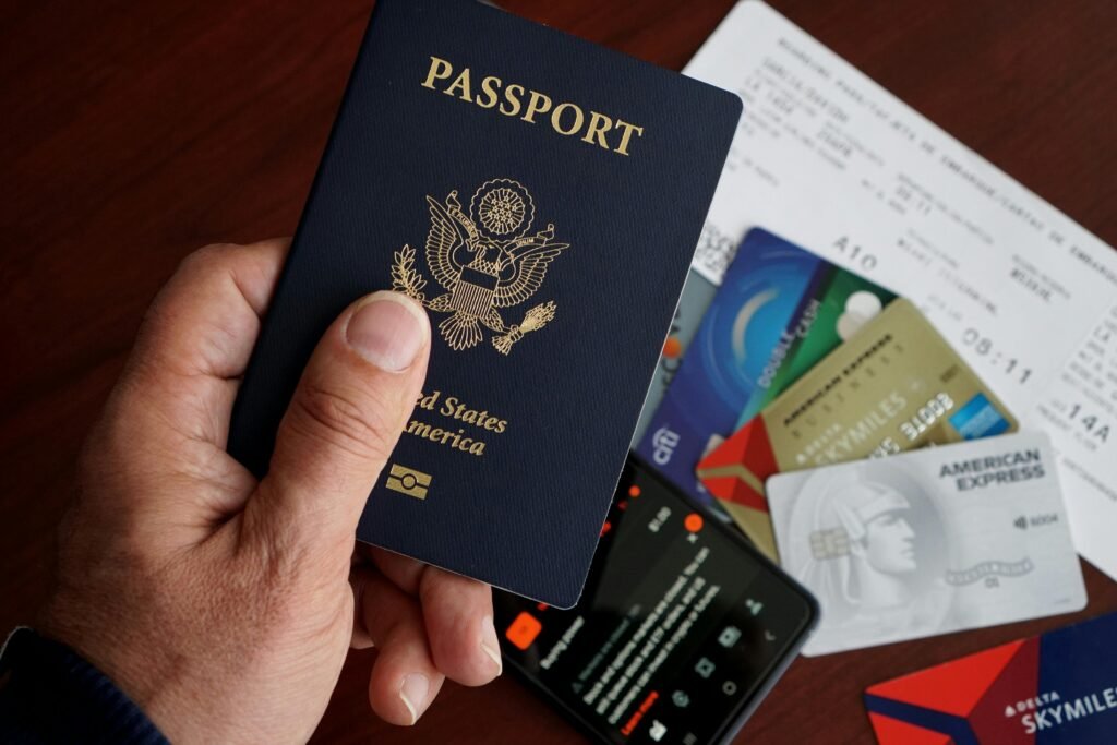 US Passport over a Smartphone Credit Cards Flight Ticket